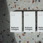 Trzy opakowania baltycki cologne na tle lastryko
